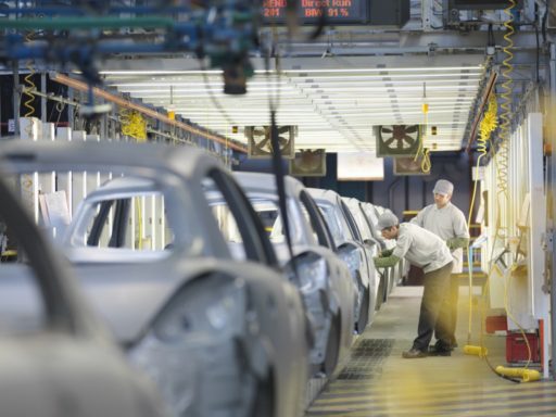 Car plant workers on a production line